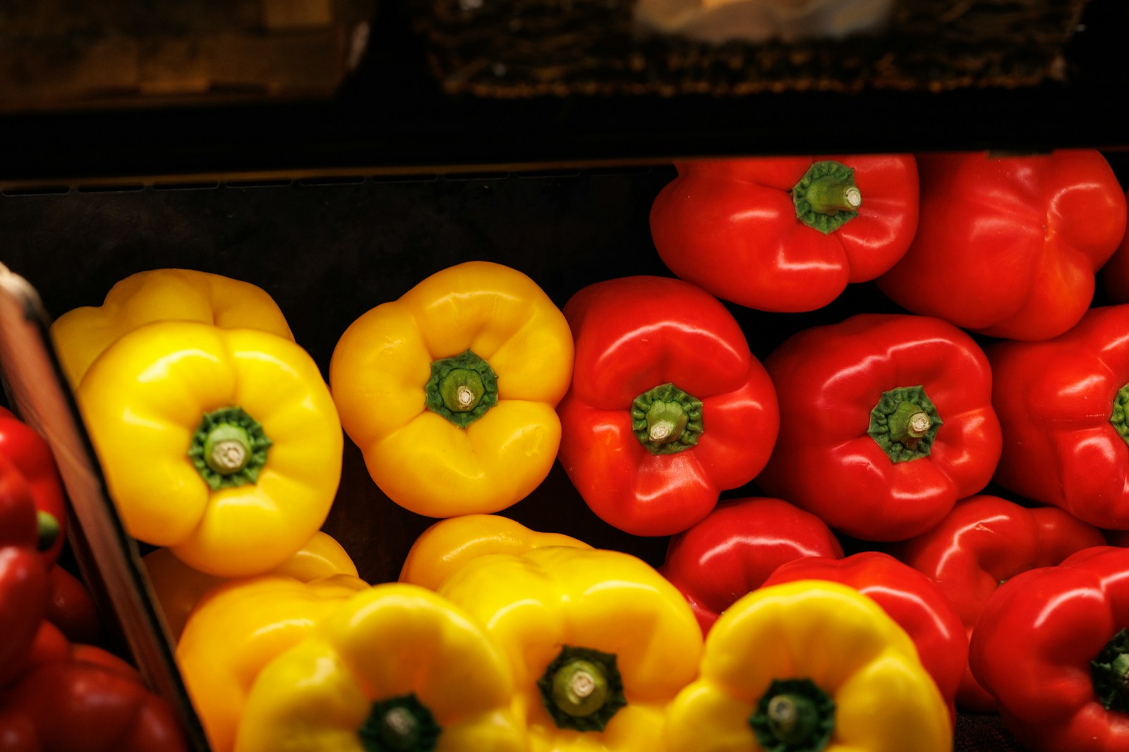 a pile of red and yellow peppers